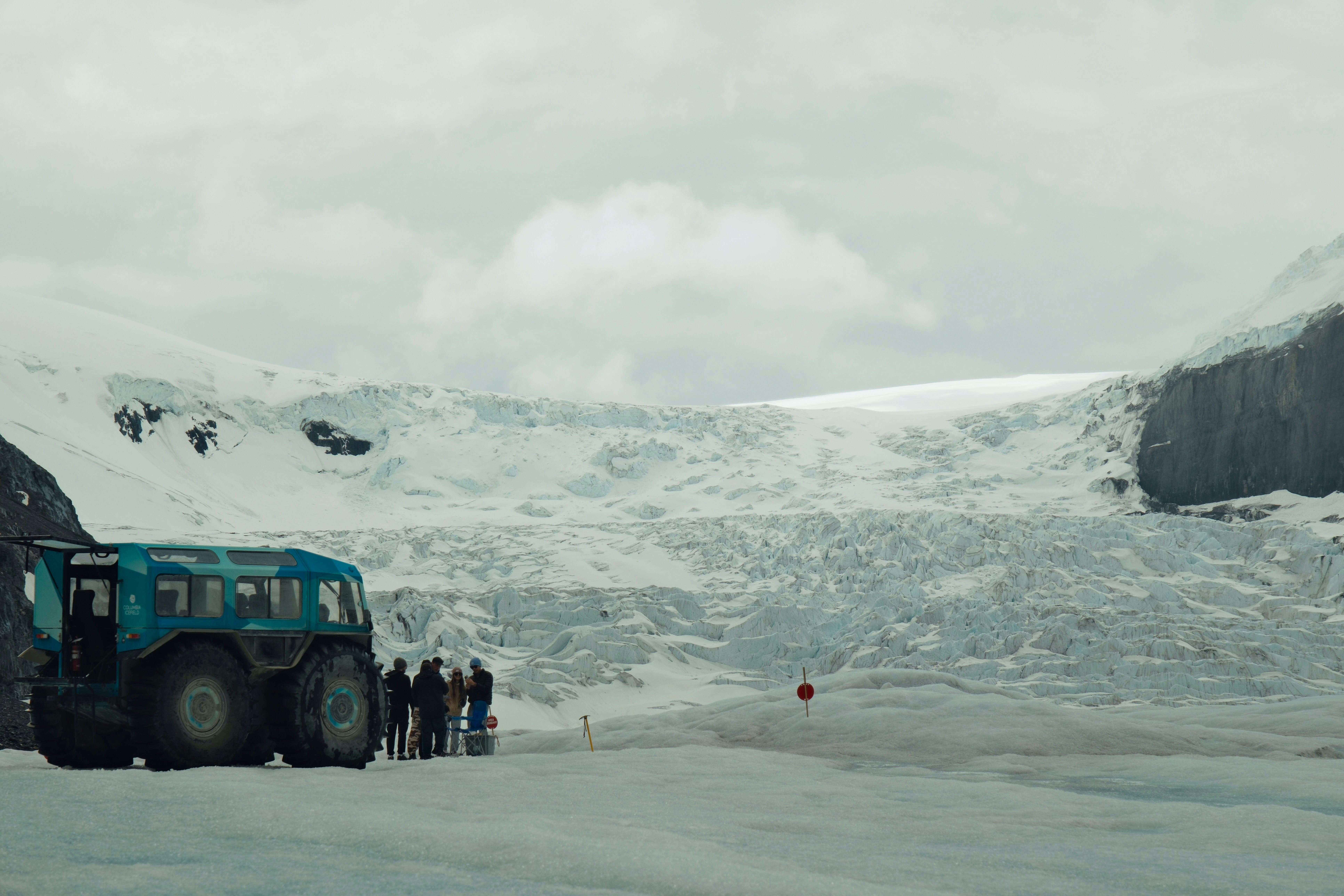 A group of people standing next to a truck