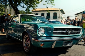A blue mustang mustang parked on the side of the road