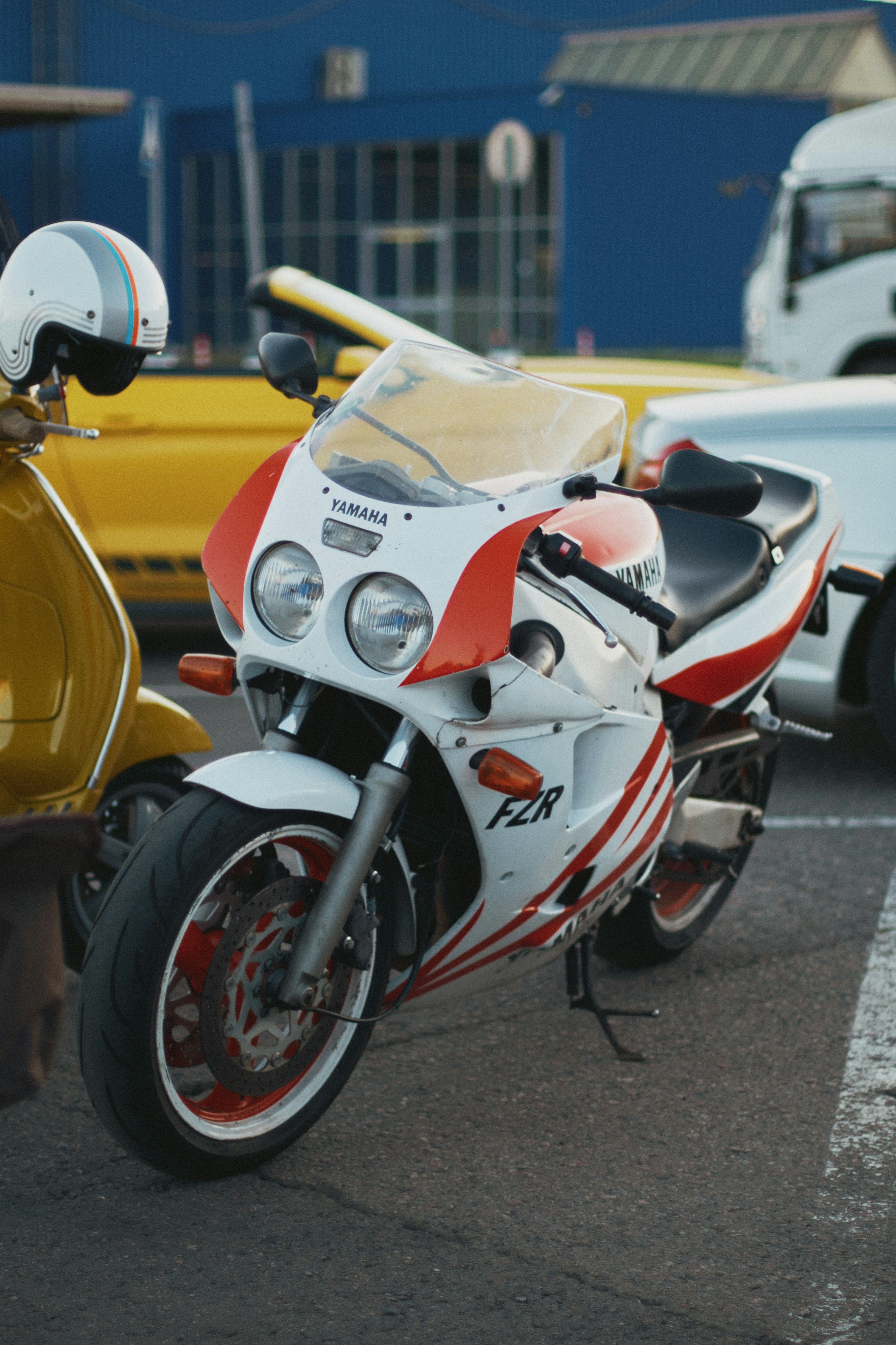 A white and red motorcycle parked in a parking lot