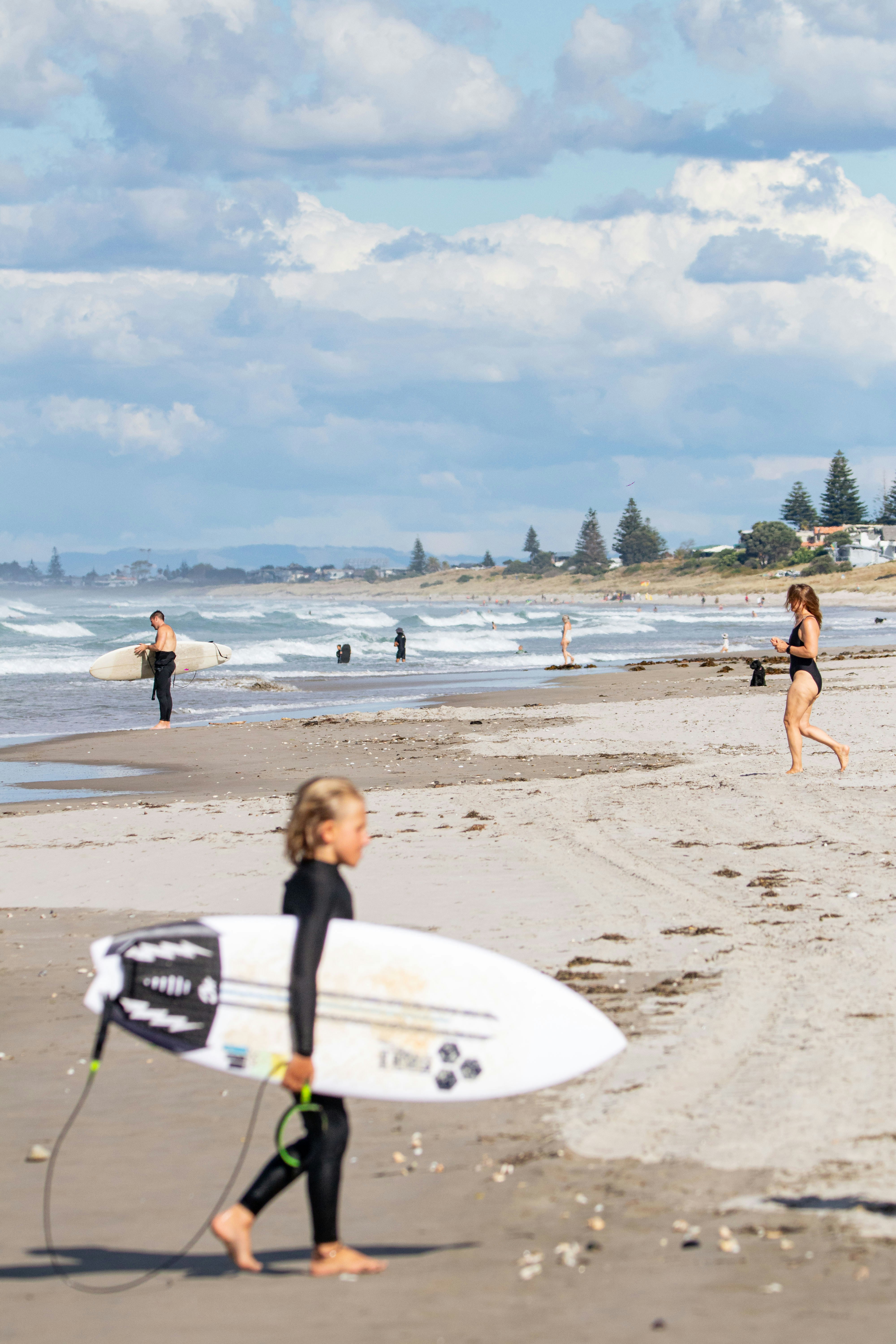 A group of people on a beach with surfboards photo Free Mount