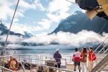 A group of people standing on top of a boat