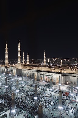 A large crowd of people standing around a building at night