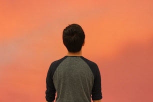 A man standing in front of a red sky