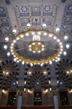 The ceiling of a large building with chandeliers