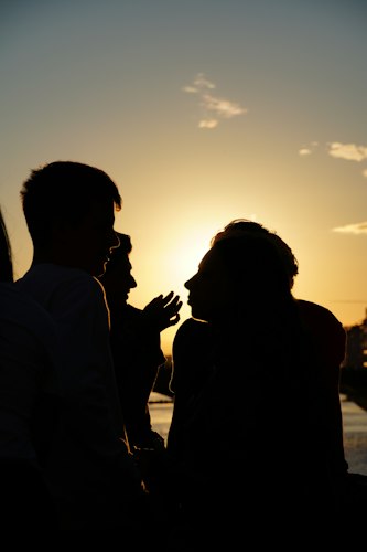 Person smiling and waving goodbye while leaving a social gathering