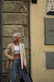 A woman standing on the street with a handbag