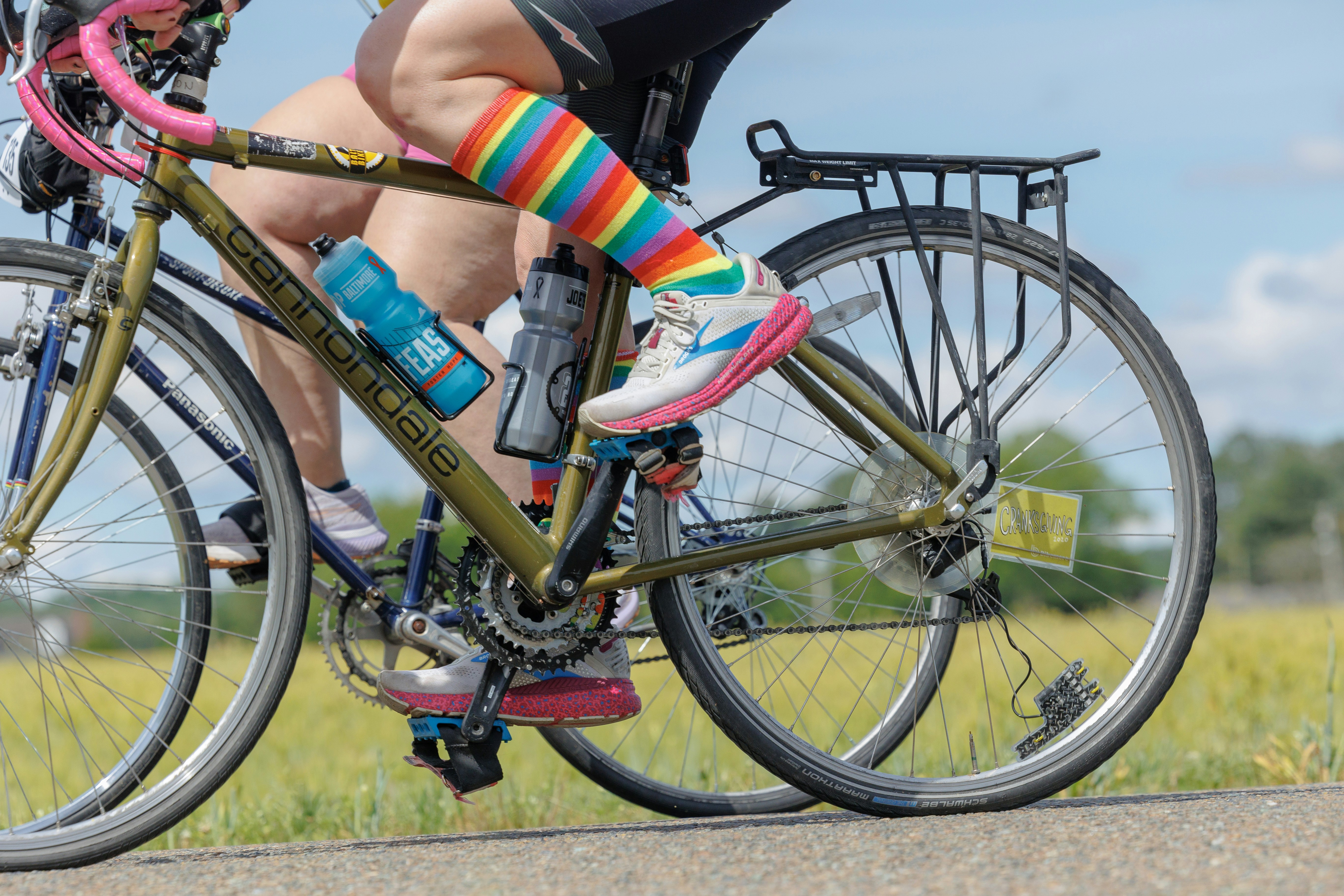 A man riding a bike down a street next to a woman