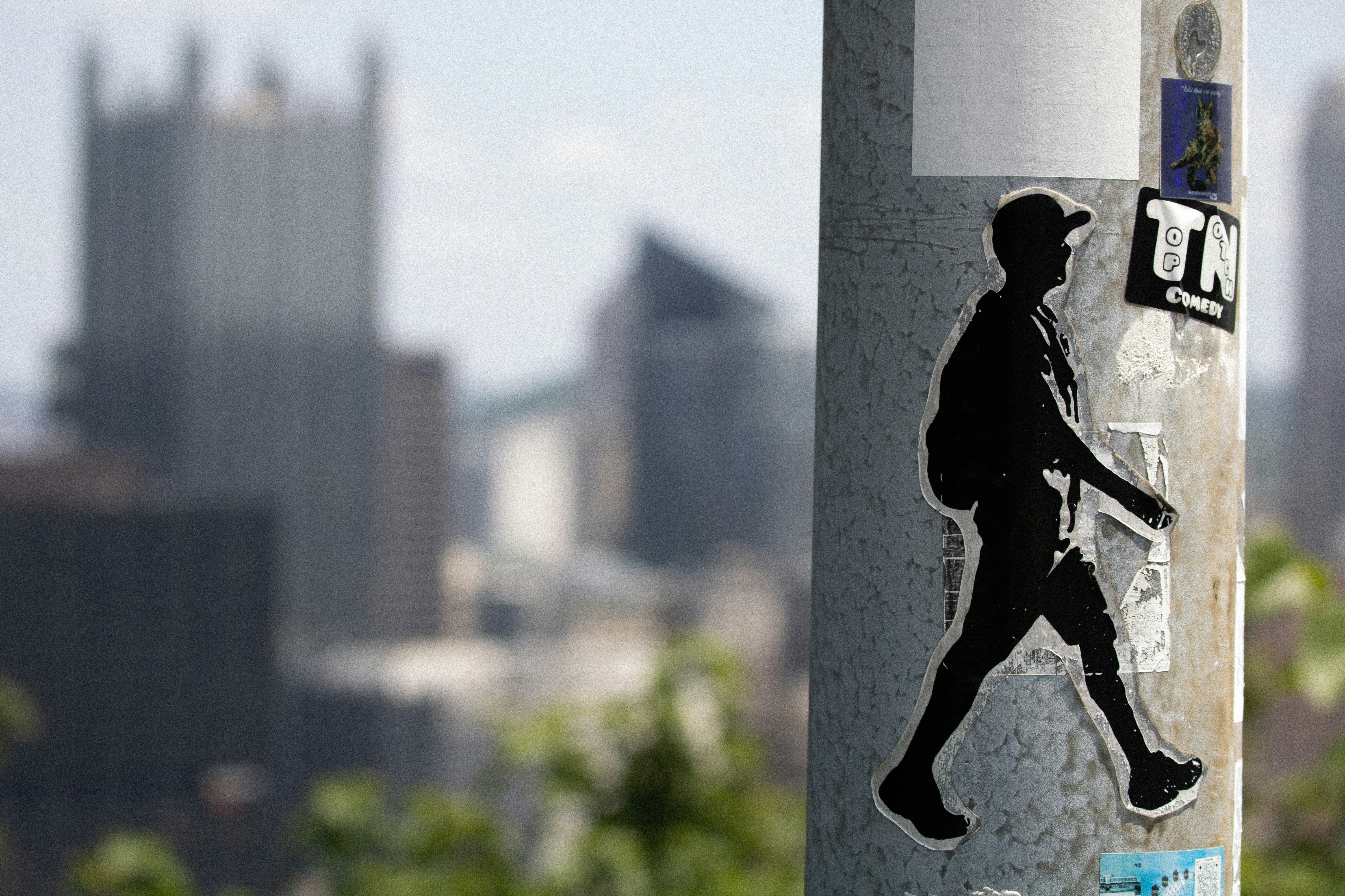 A close up of a street sign with a city in the background