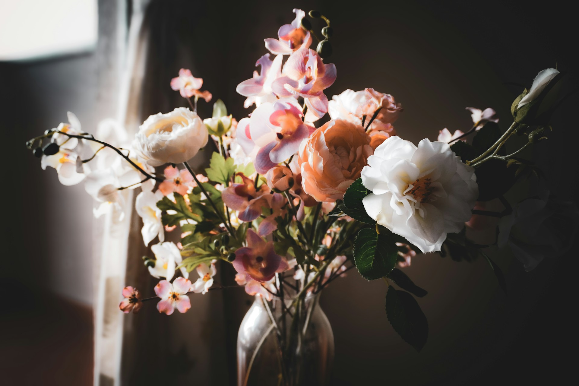 A vase filled with lots of flowers on top of a table