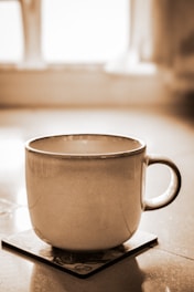 A coffee cup sitting on top of a scale