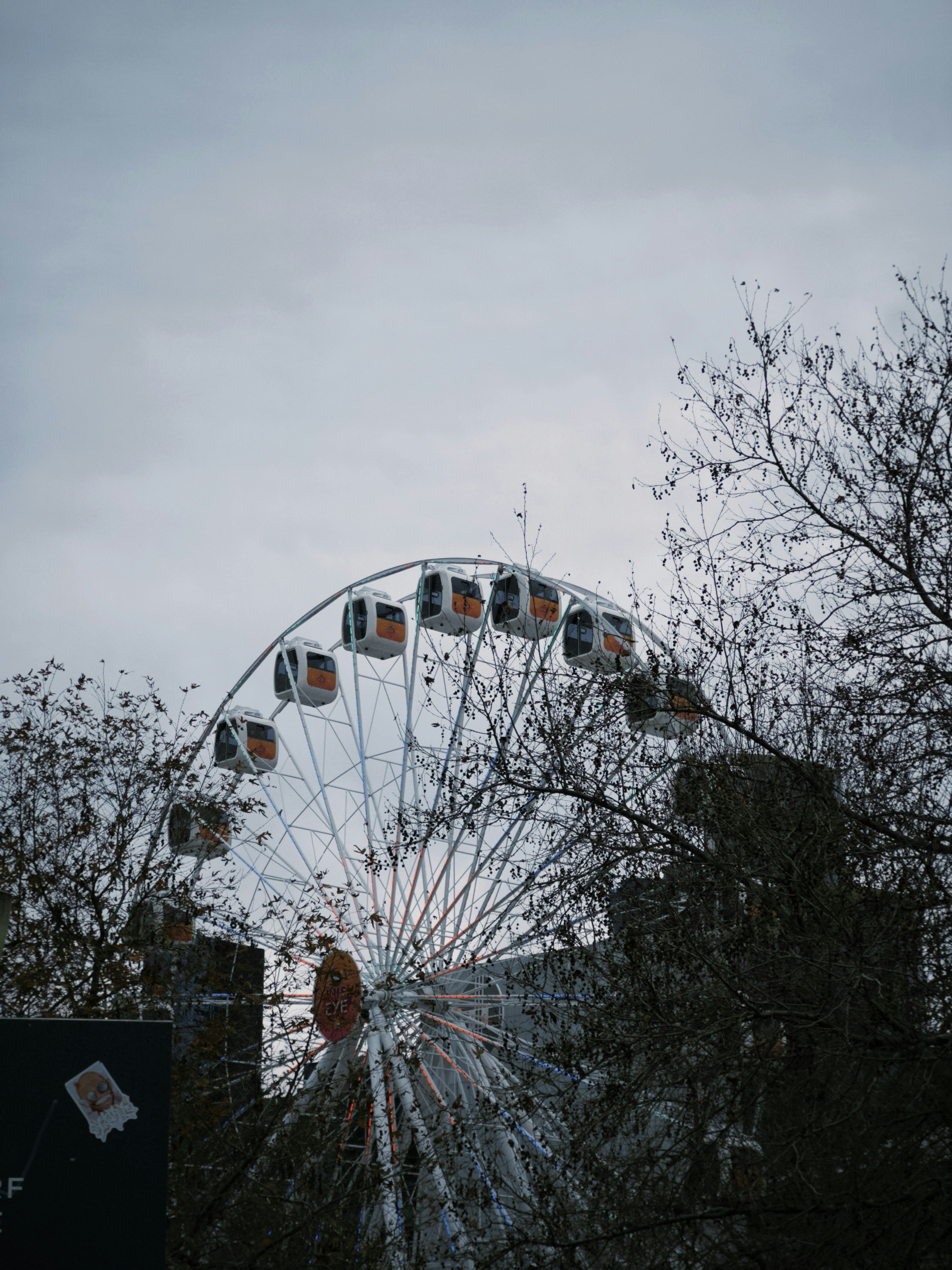 A large ferris wheel sitting next to a tall building