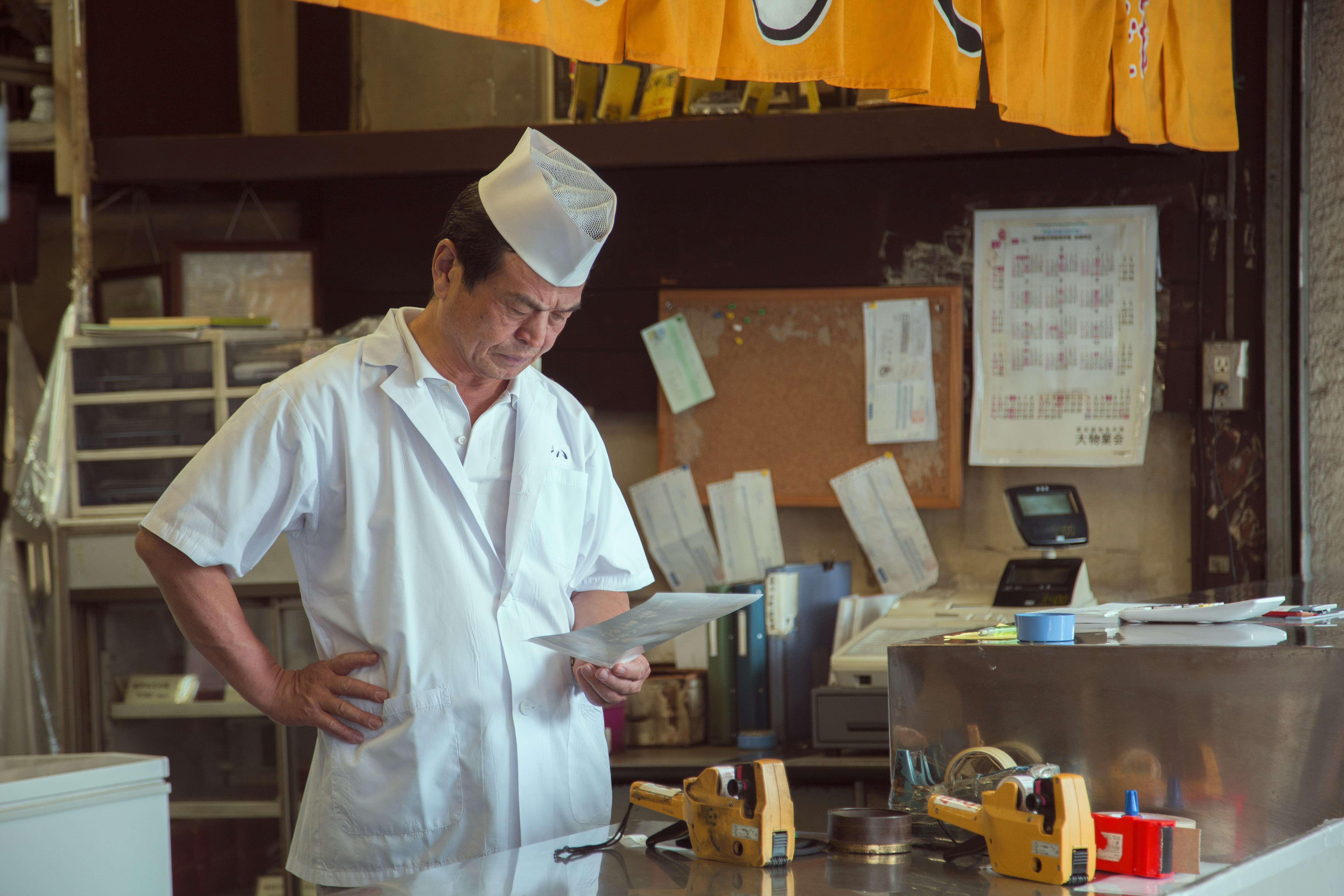 A man in a chef's outfit standing in front of a counter