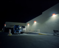 A truck parked in a parking lot at night