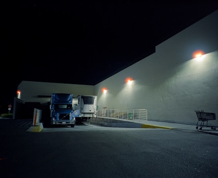 A truck parked in a parking lot at night