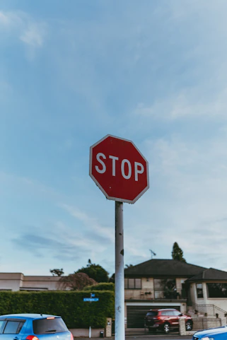 A red stop sign sitting on the side of a road