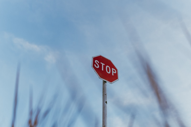 A red stop sign sitting on top of a metal pole