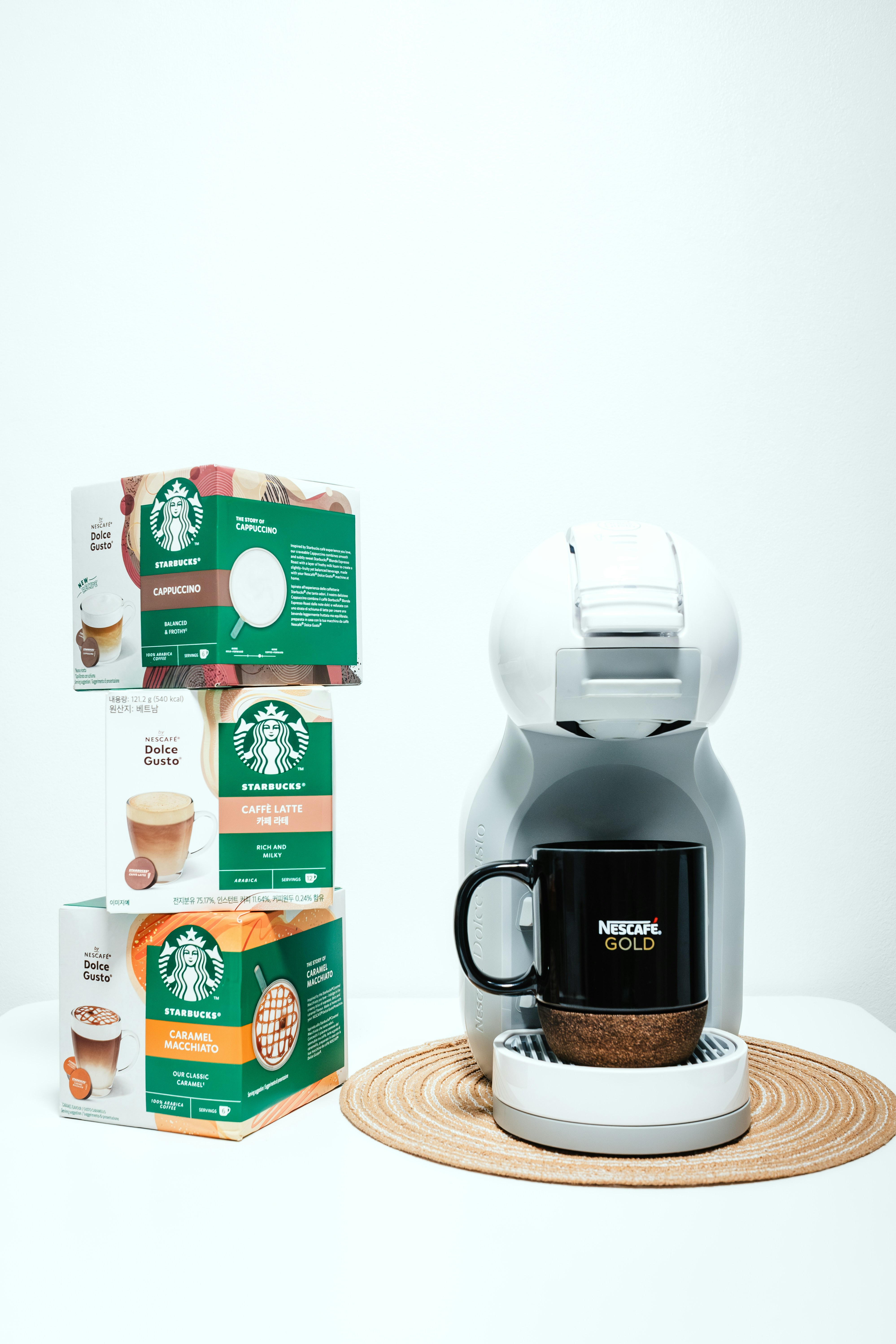 A starbucks coffee maker next to a box of coffee