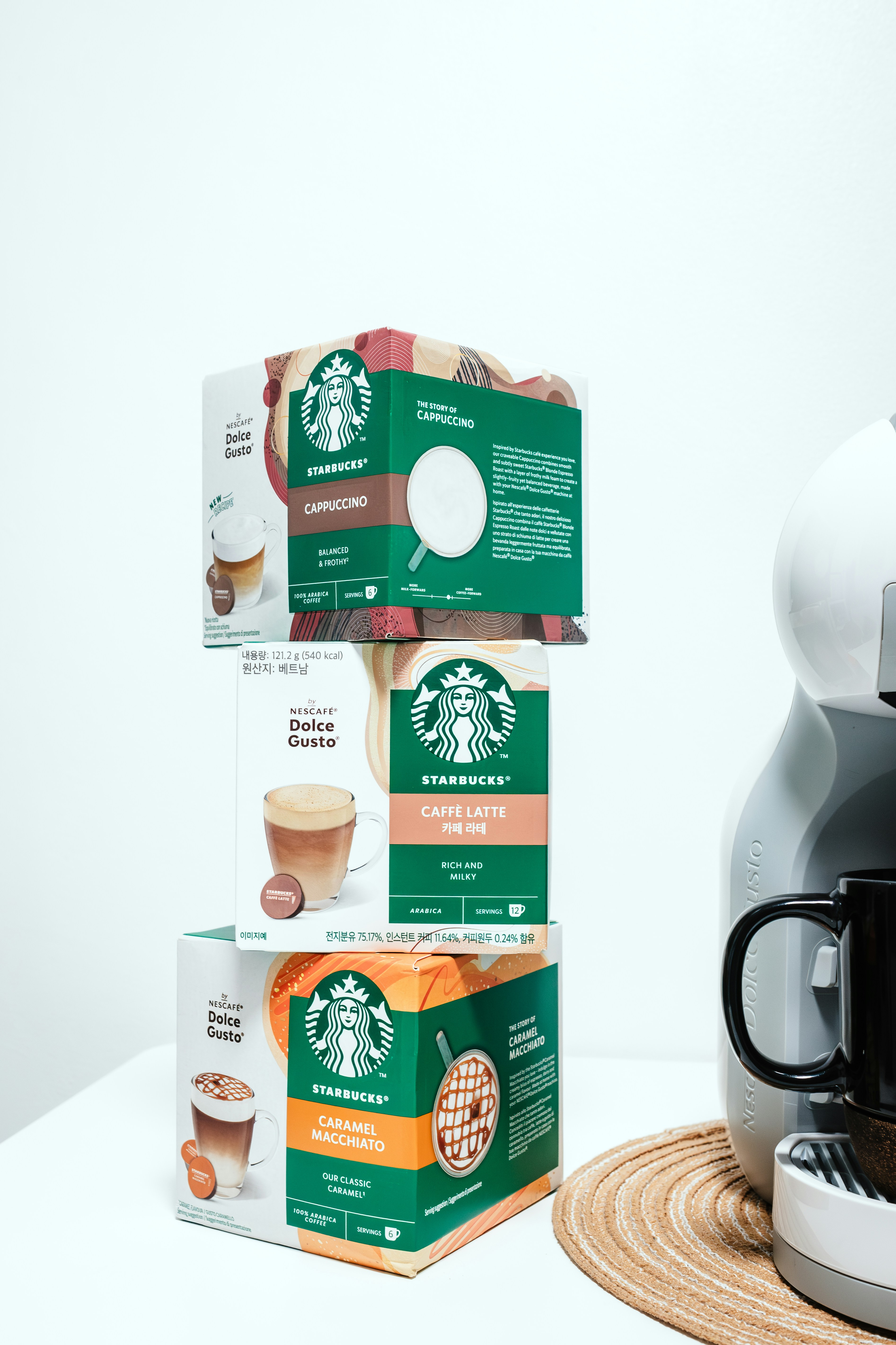 A starbucks coffee maker next to a box of coffee