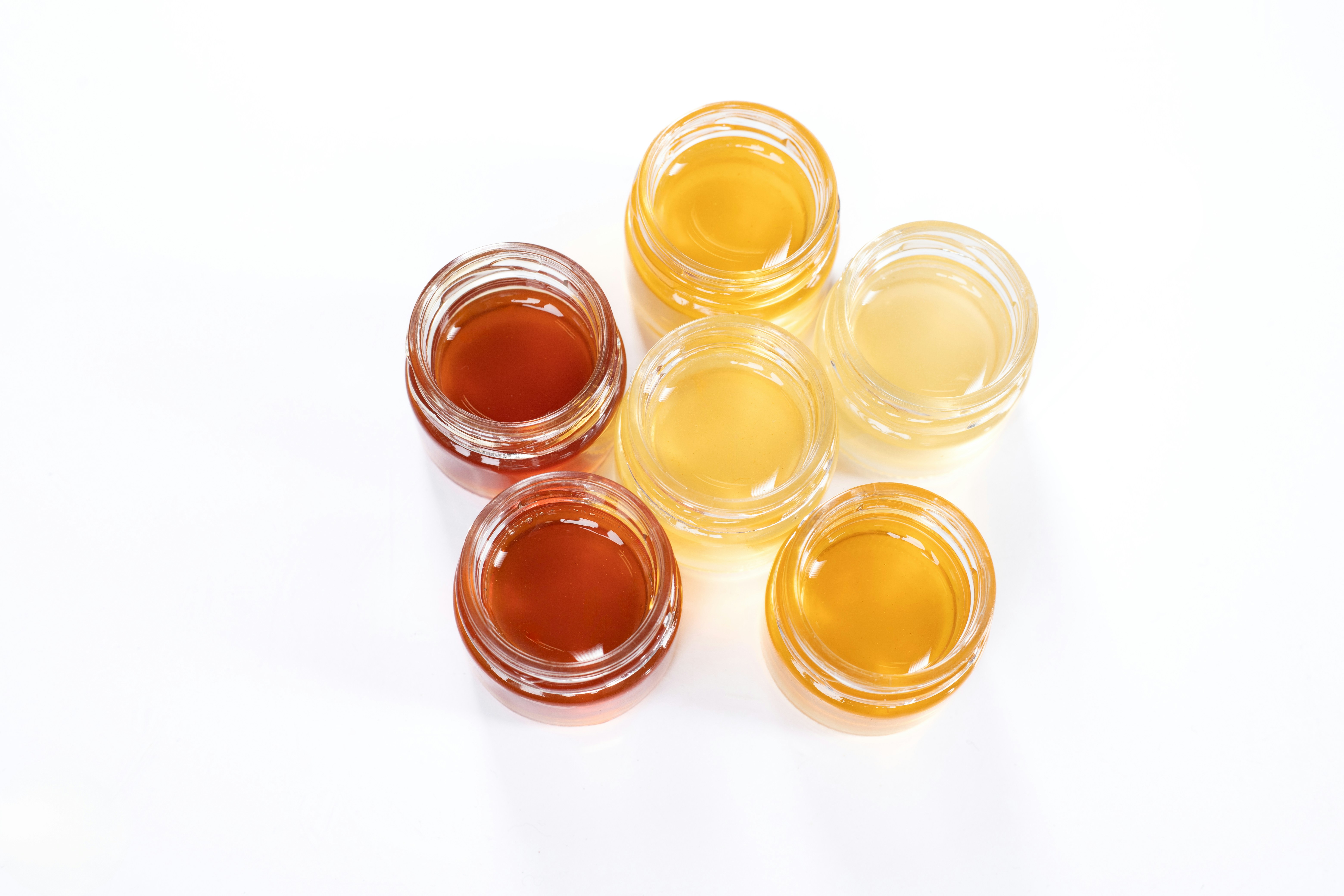 A group of small jars filled with liquid