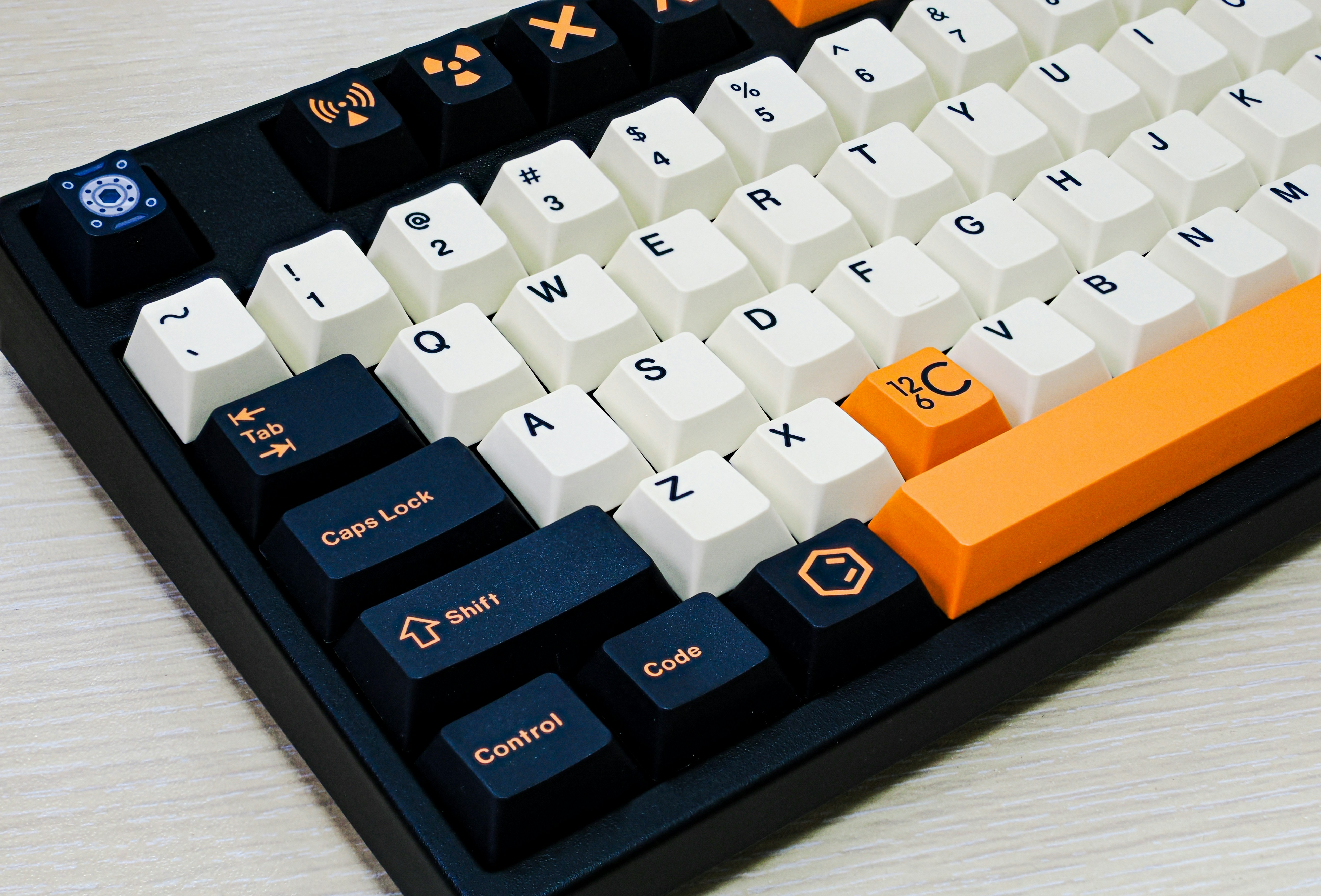 A computer keyboard sitting on top of a wooden table