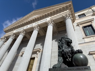 A building with columns and a statue in front of it