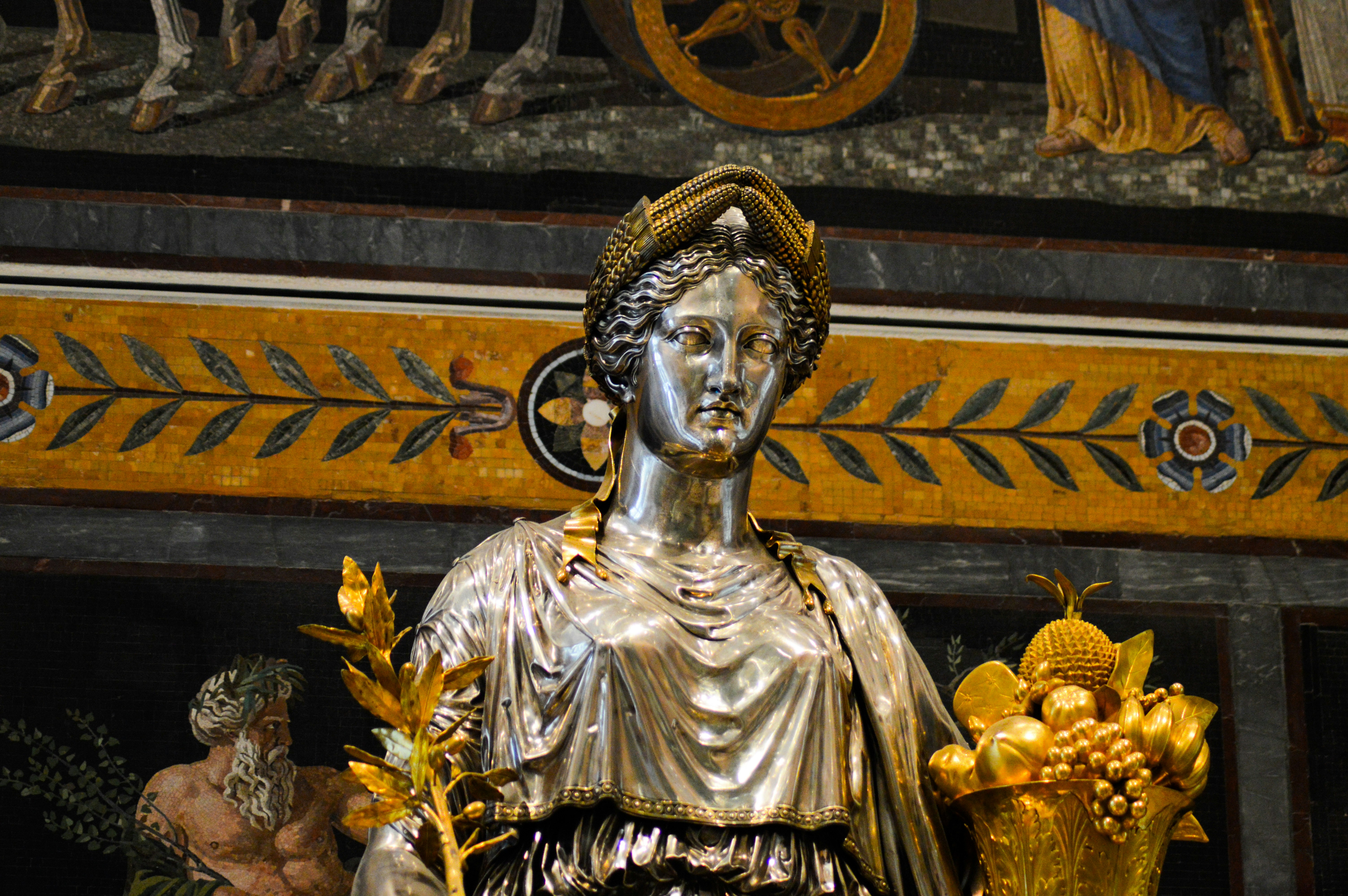 A statue of a woman holding a bunch of flowers