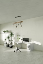 A white room with a desk, chair and potted plants