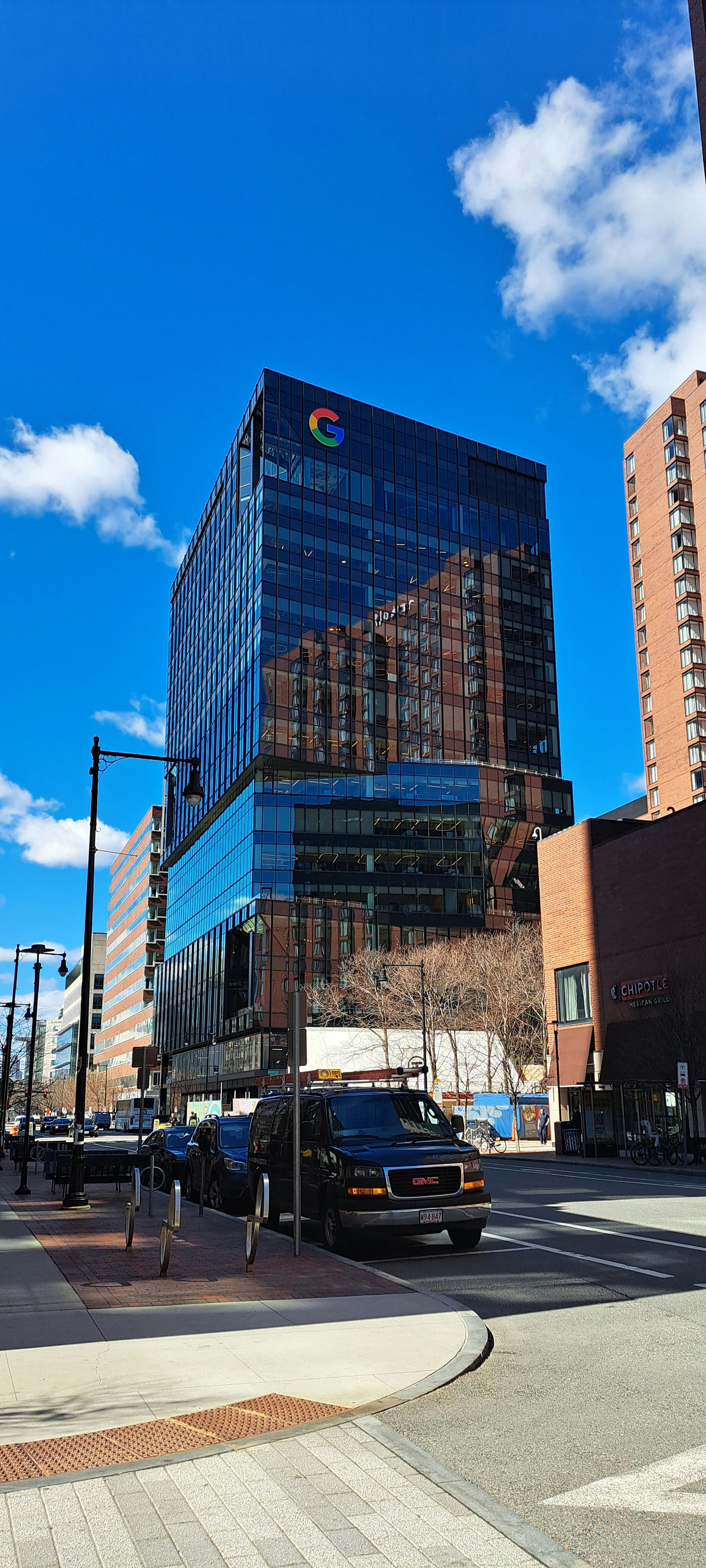 A city street with a traffic light and tall buildings