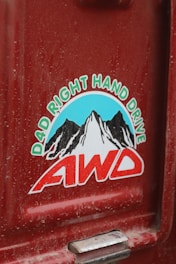 A sticker on the side of a red truck