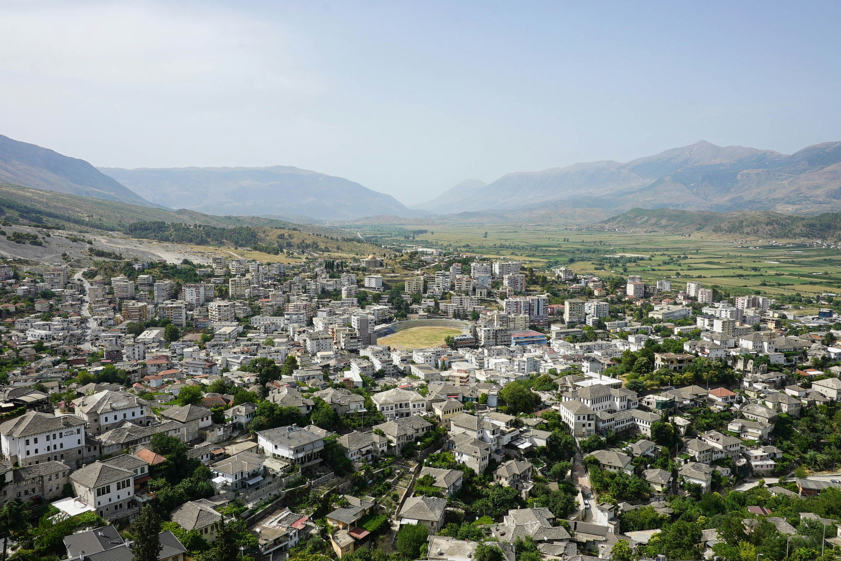 An aerial view of a city with mountains in the background
