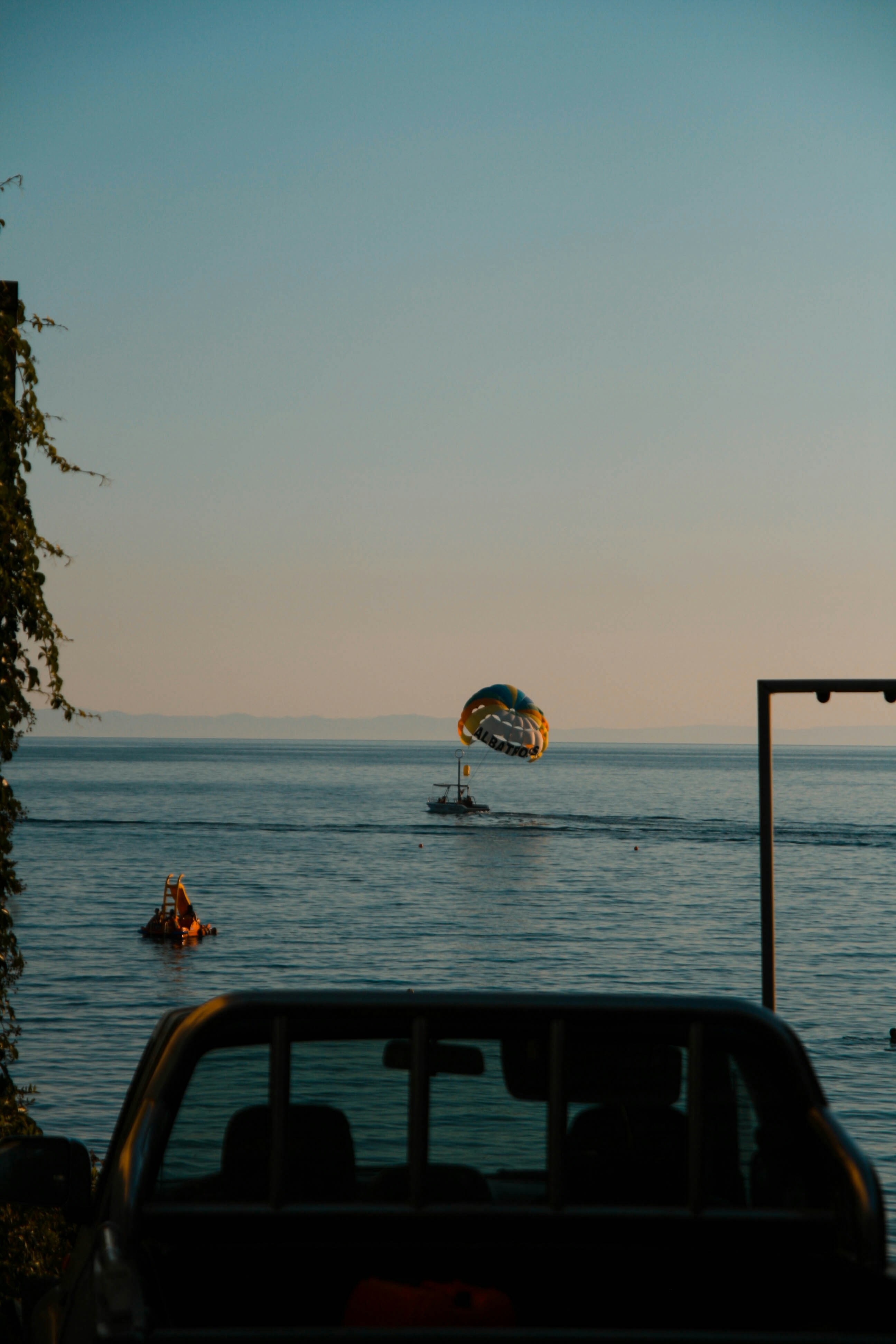 A group of people riding on top of a boat in the ocean
