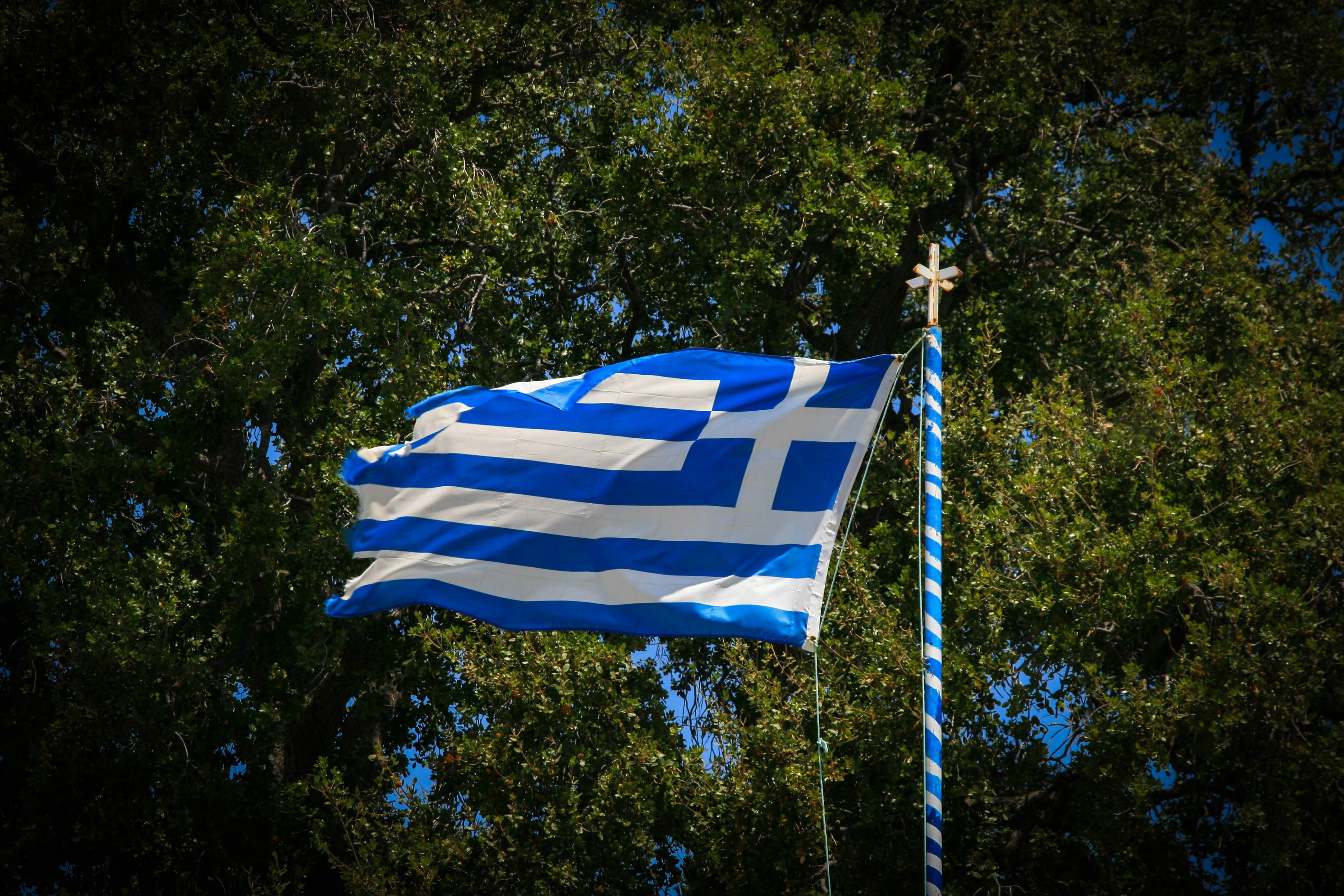 The flag of the country of greece flying in the wind