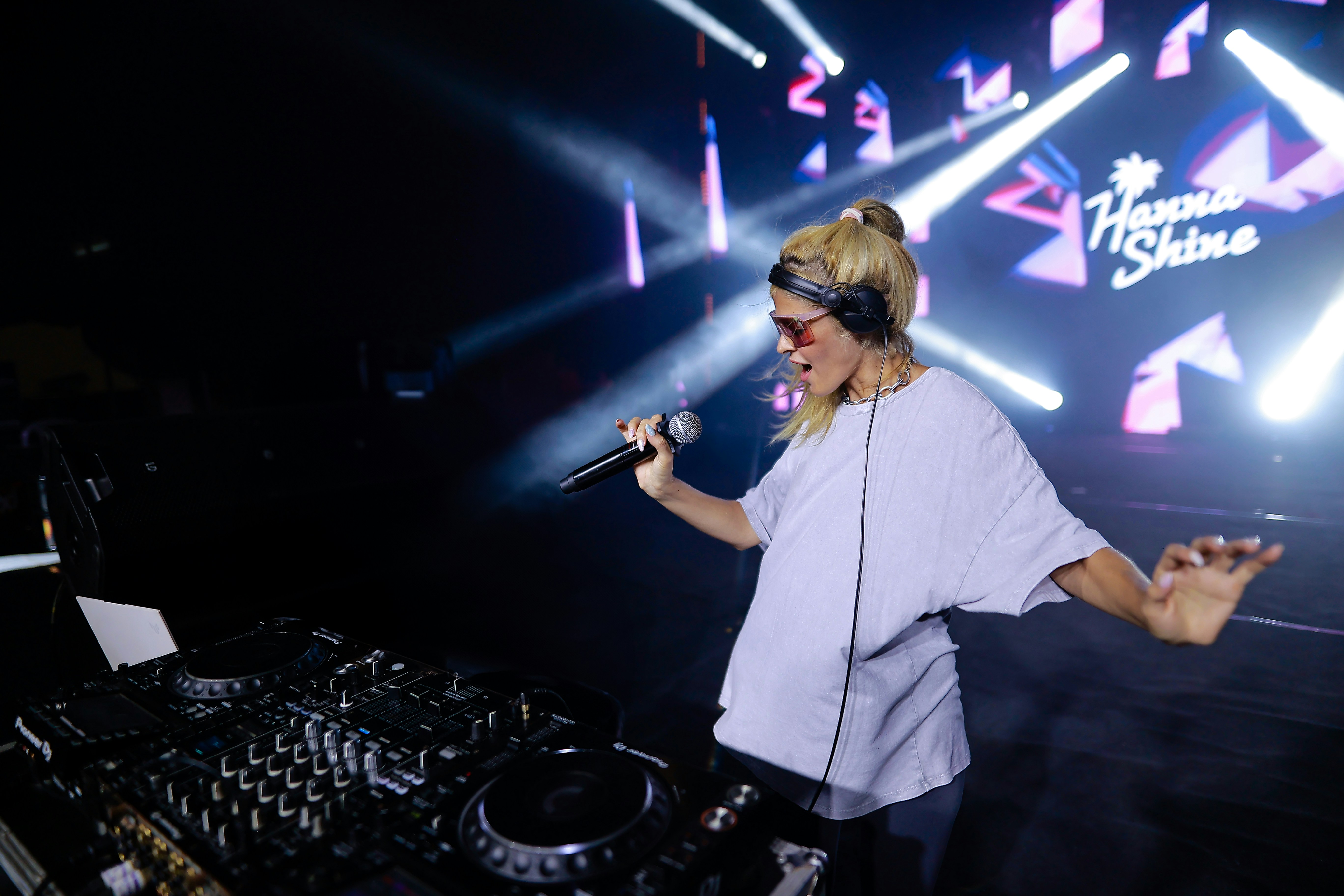 A woman standing in front of a dj set