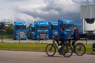 A group of people riding bikes down a street