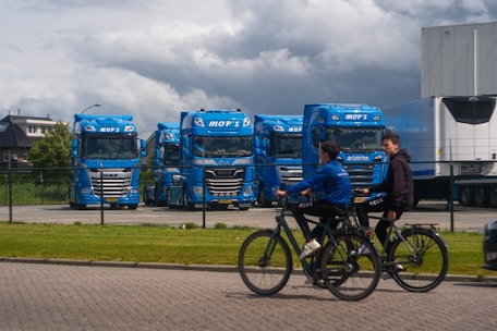 A group of people riding bikes down a street