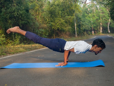A man doing a push up on a blue mat