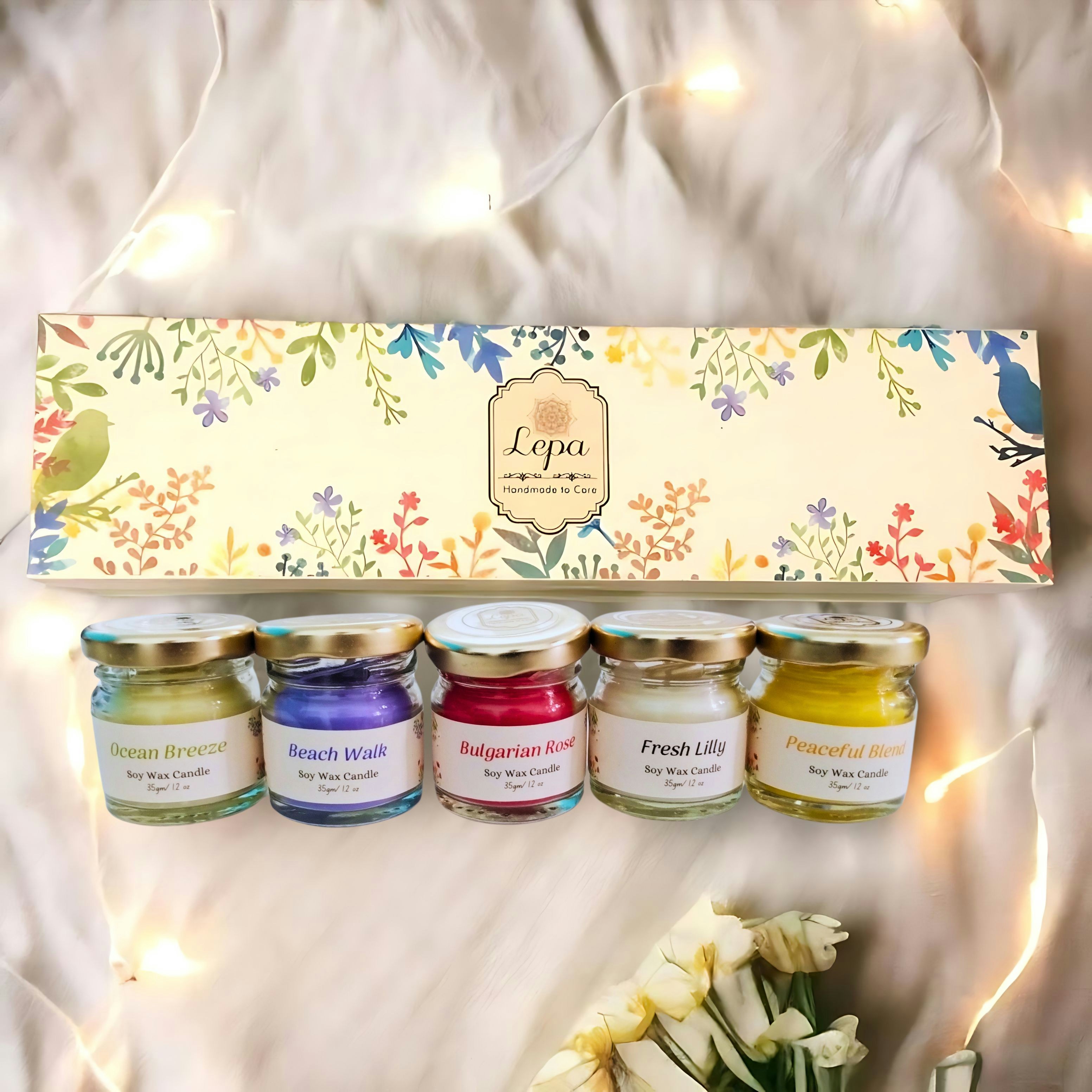 A box of candles and some flowers on a bed