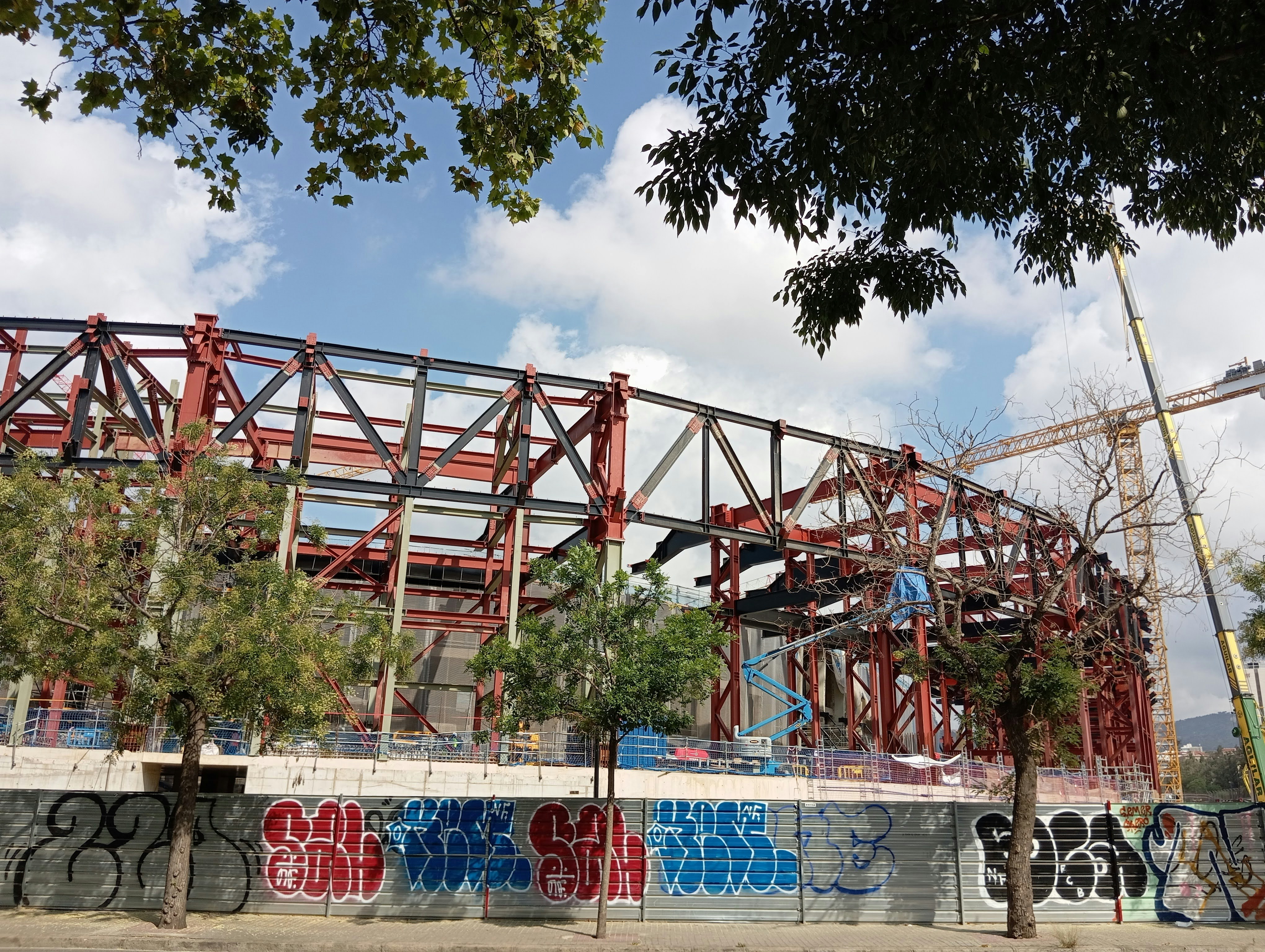 A construction site with graffiti on the side of it