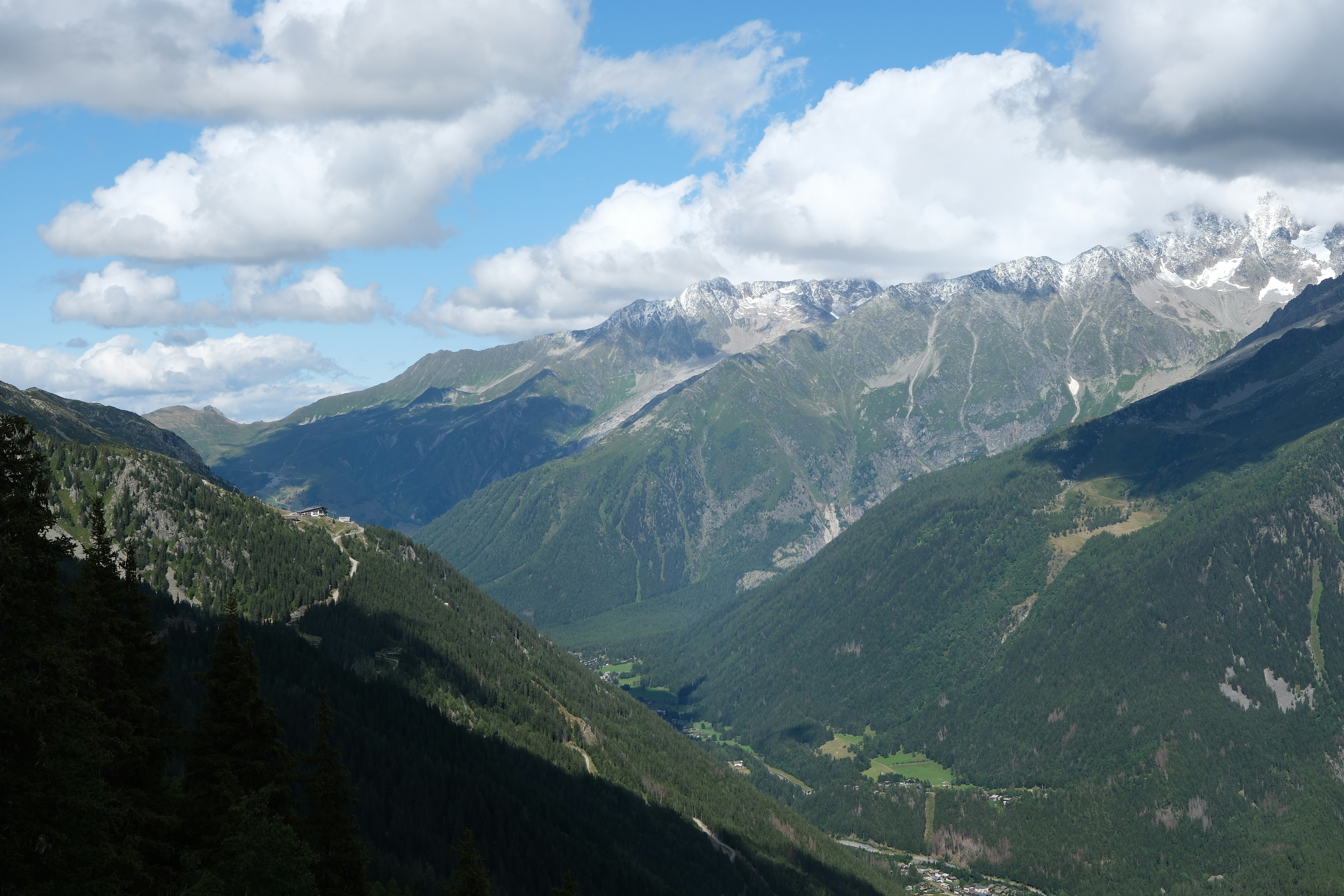 A view of a valley with mountains in the background