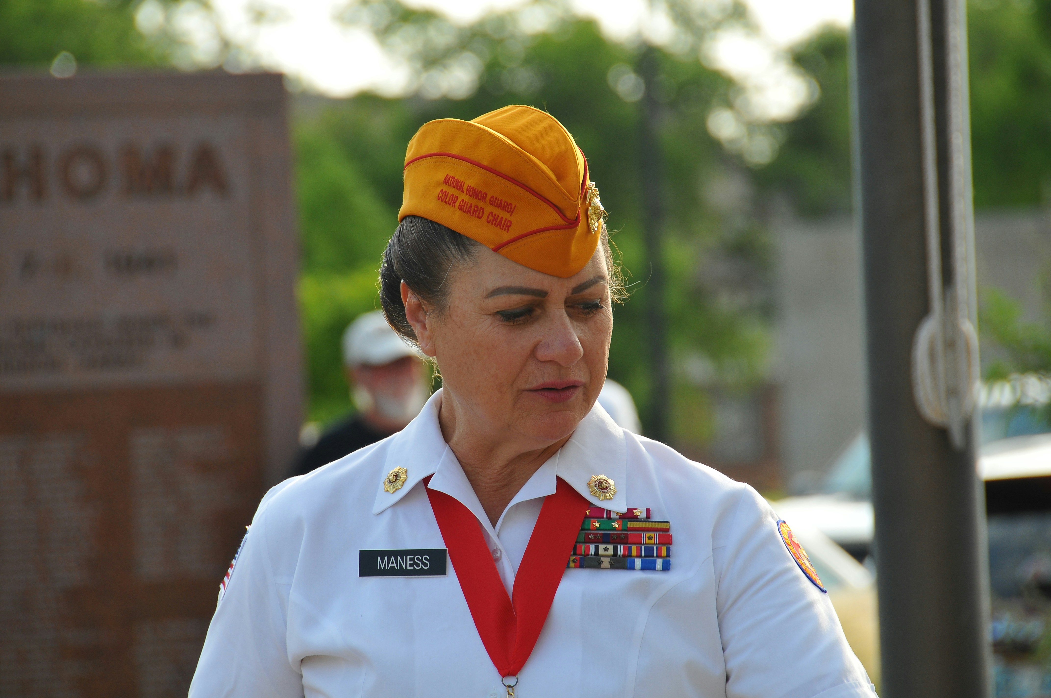 A woman in a white uniform and a yellow hat