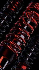 A group of red and black springs on a black background