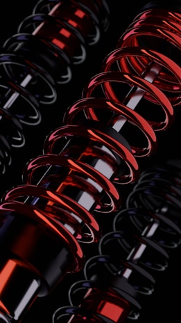 A group of red and black springs on a black background