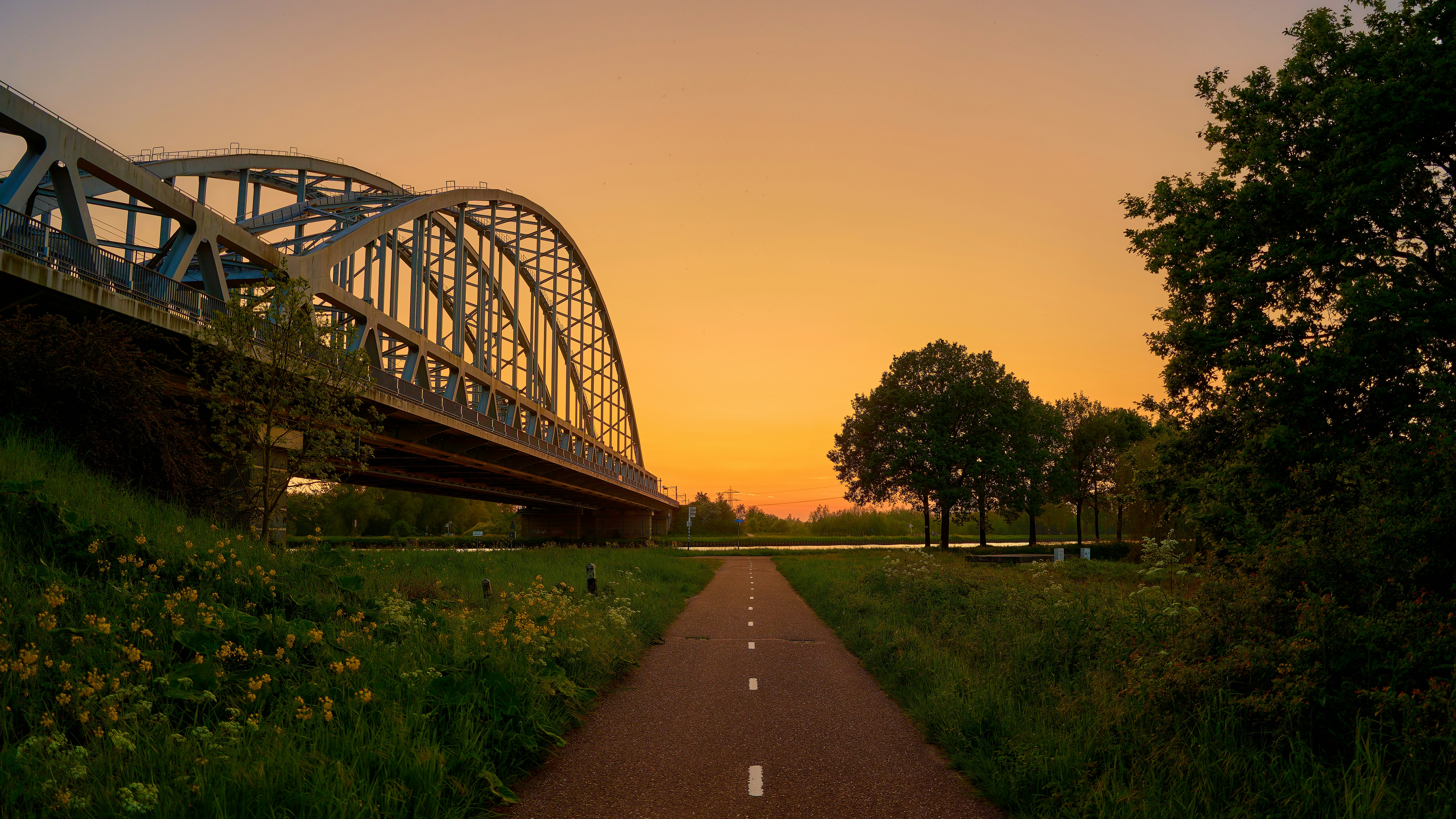 A long road with a bridge in the background