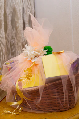 A basket with a note pad and a bow on it