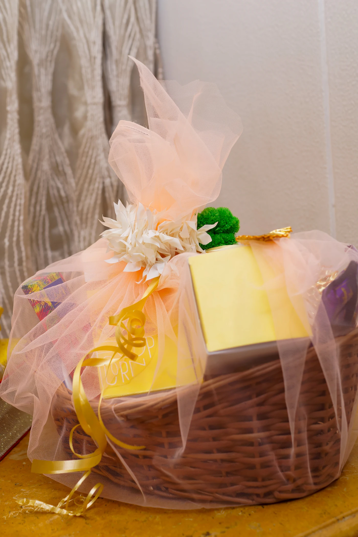 Wicker hamper basket wrapped in soft blush tulle