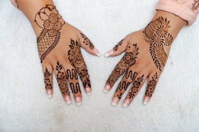 A woman's hands with henna tattoos on them