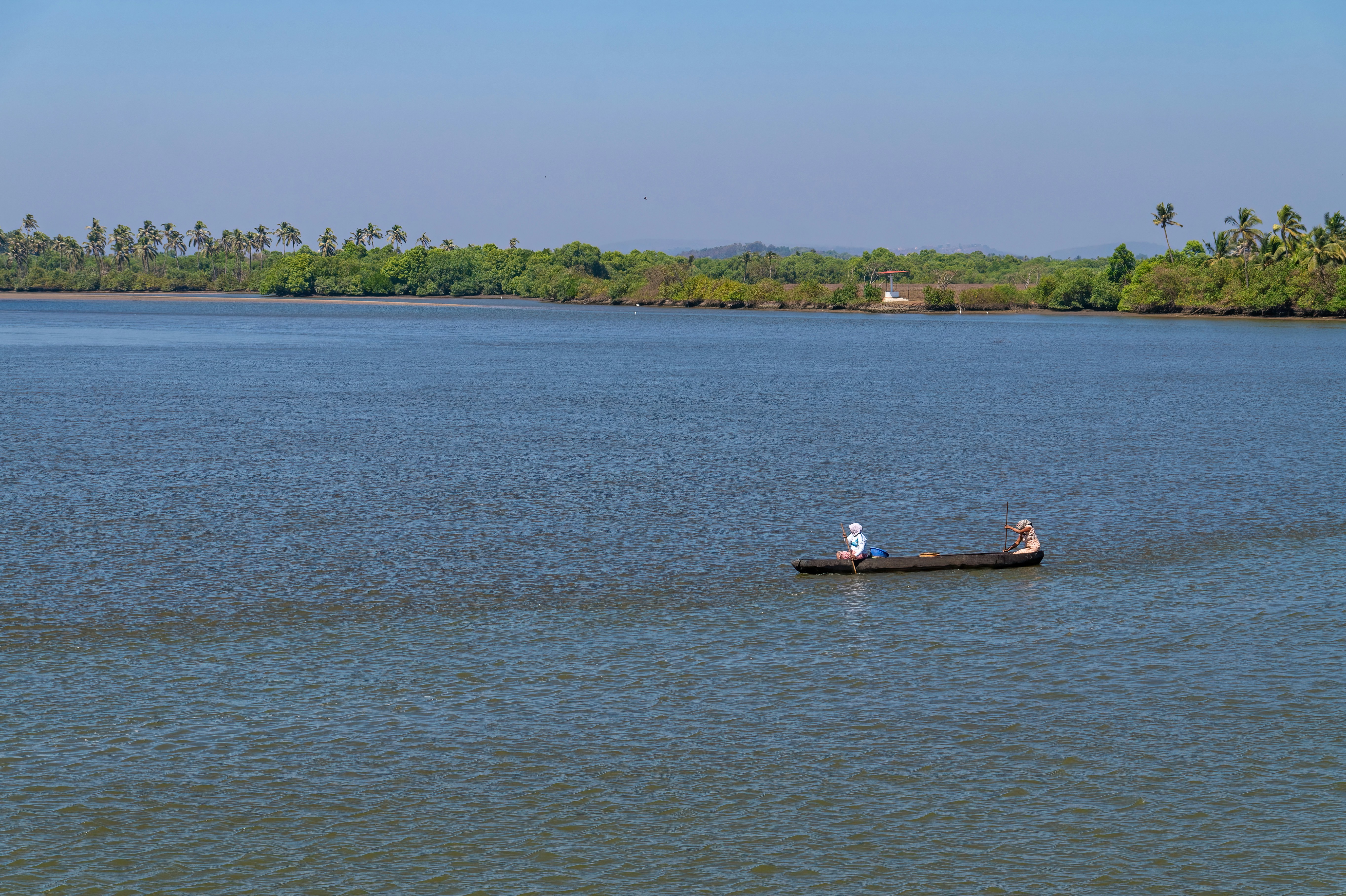 A boat floating on top of a large body of water
