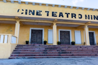 A yellow building with steps leading up to it
