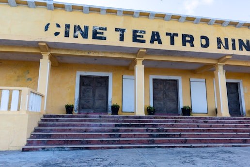 A yellow building with steps leading up to it