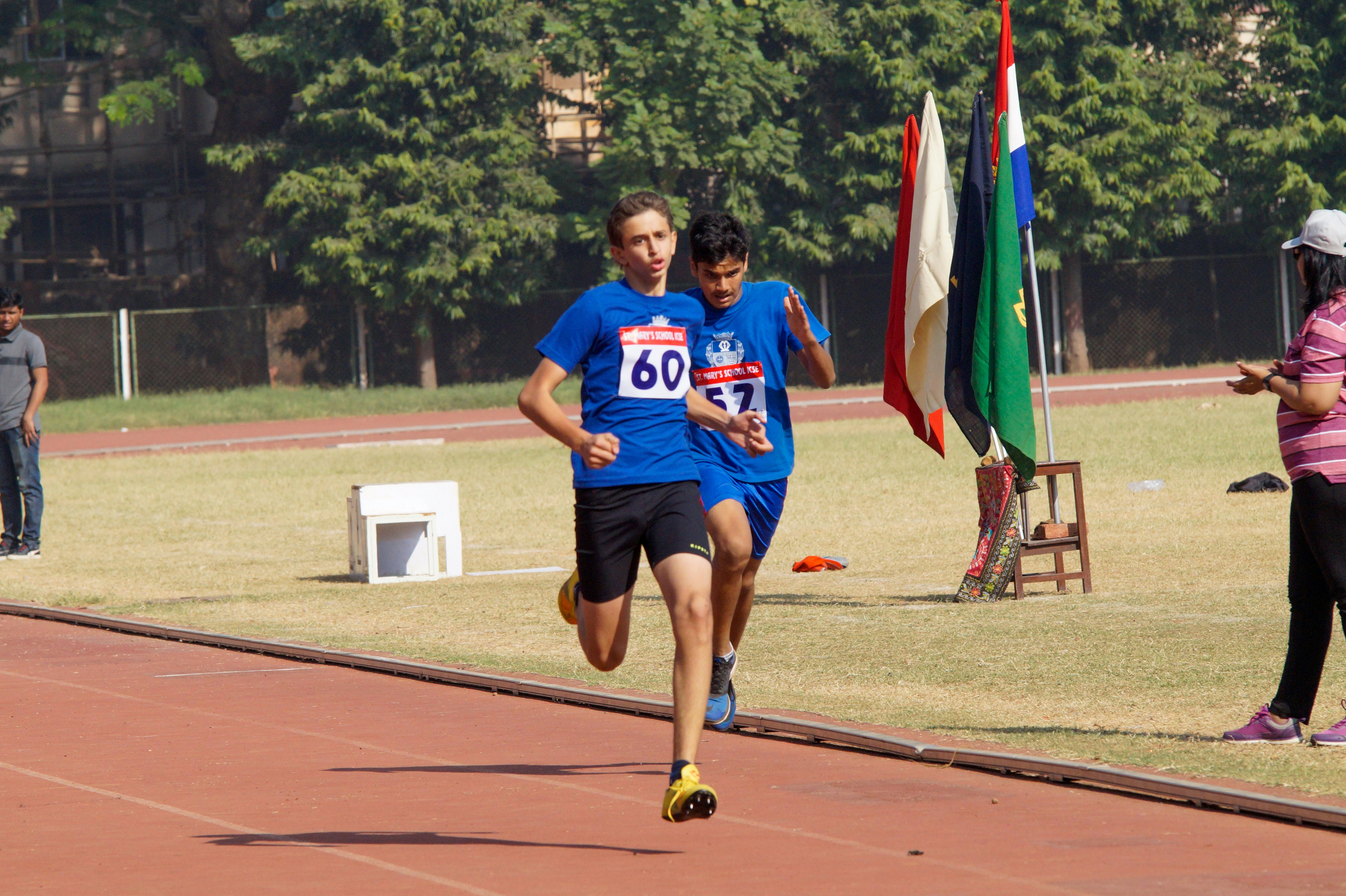 Group of people running on a track